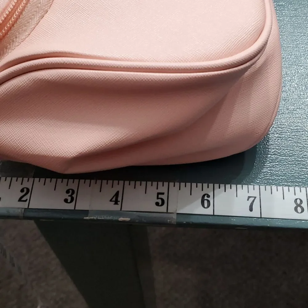 Two cosmetic bags.‎ One in vintage and homemade. The other is pink and la…